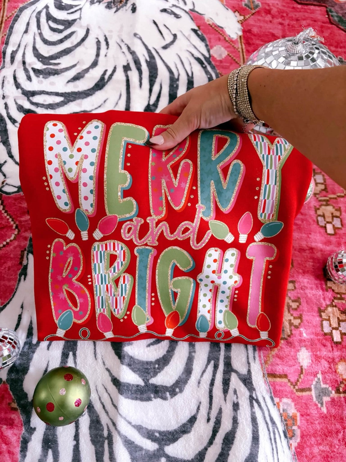 Merry and Bright red Christmas crewneck flat lay